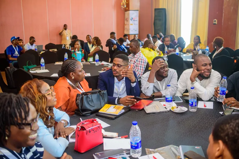 Attendees collaborating around a table during a hands-on session